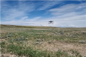 Drone flying above ground.