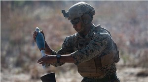 US Marine loads a round in an 81 mm mortar system U.S. Marines &copy;